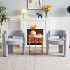 Two gray velvet barrel accent chairs with curved backrests and thick cushions, perfect for modern living room decor.