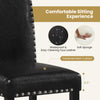 Close-up of a dining chair with thick padded seat, waterproof faux leather, and elegant nailhead accents for comfort.