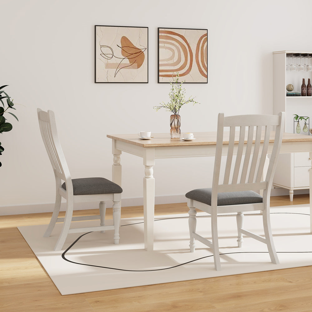 Set of 2 white dining chairs with solid wood legs and gray cushions, ideal for kitchen or dining room use.