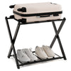 Folding metal luggage rack in black with suitcase and shoes, perfect for modern bedroom or hotel storage.