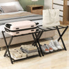 Folding metal luggage rack set in black with suitcase, shoes, and bags, ideal for bedroom or hotel storage.