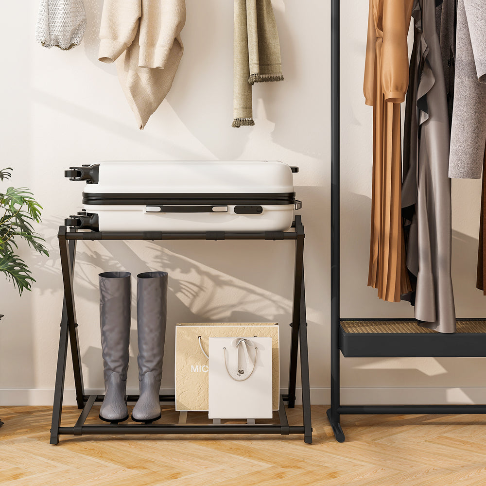 Folding metal luggage rack in black with suitcase and boots, ideal for bedroom or hotel storage solutions.