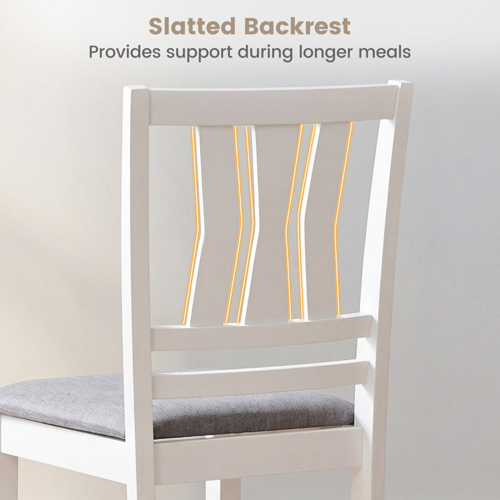 Slatted backrest of a linen-style upholstered dining chair, providing support for longer meals in a modern farmhouse.