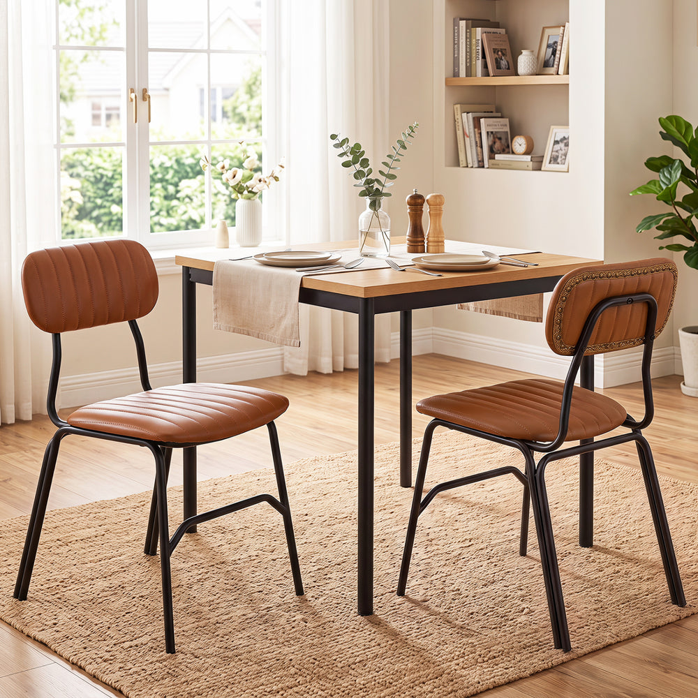 Set of 2 modern dining chairs with brown PU leather seats, ergonomic backs, and solid metal legs for stylish dining.