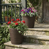 Set of 2 brown plastic tapered rattan planters with drainage holes, perfect for indoor and outdoor floral displays.