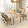 Top view of a dining table with two rattan accent chairs featuring gray cushions, perfect for enhancing farmhouse decor.
