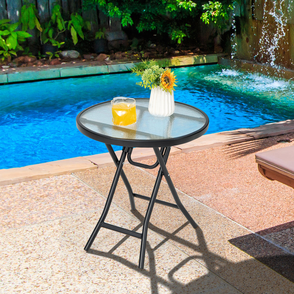 Round patio side table with tempered glass top and black powder-coated frame, ideal for small indoor and outdoor spaces.
