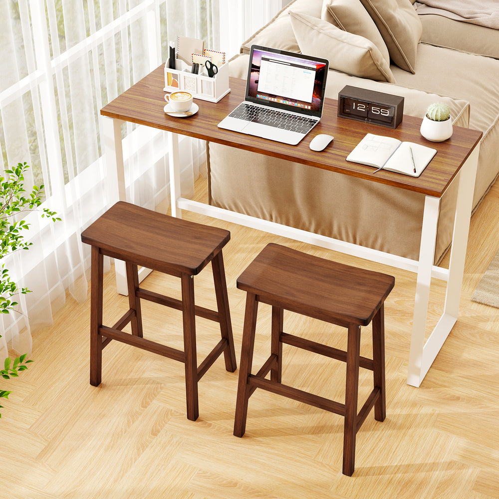 Set of 2 walnut saddle-seat counter height stools with curved seats and footrests, perfect for kitchen or dining use.