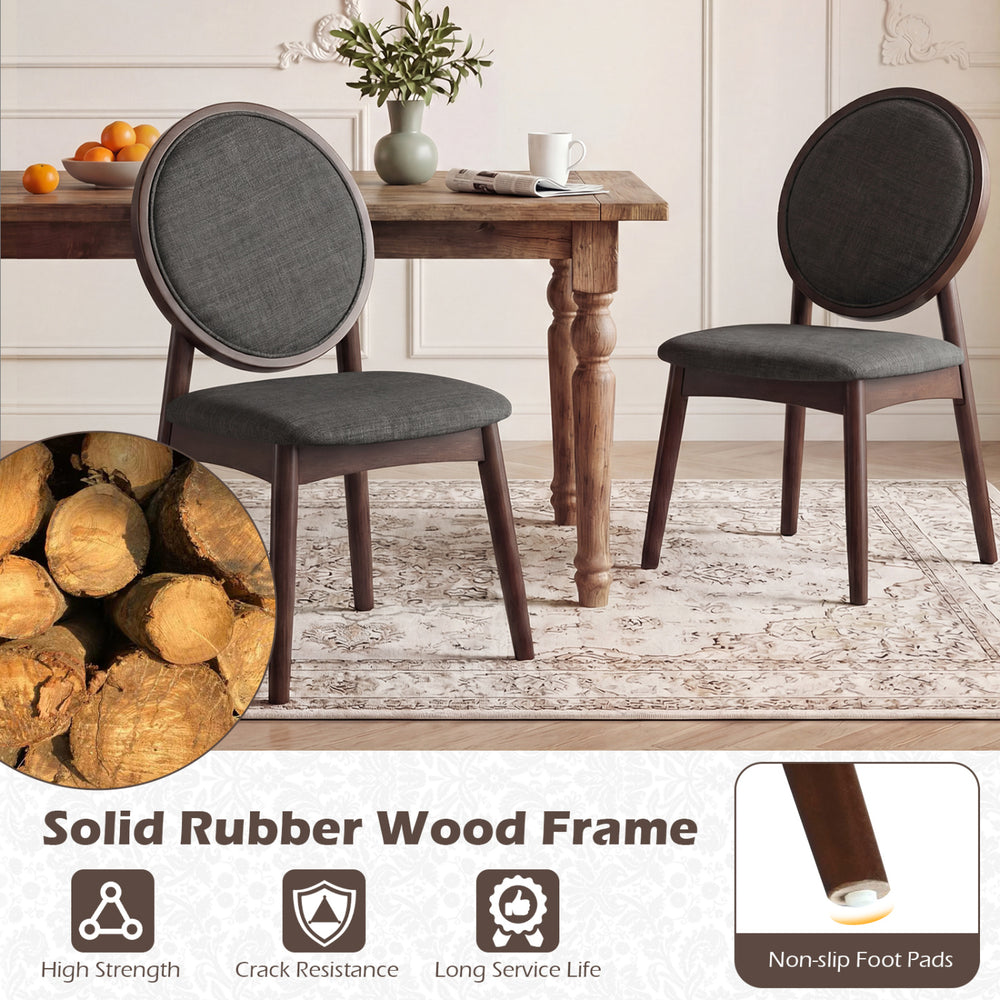 Set of 2 black upholstered kitchen side chairs with solid rubber wood frame and ergonomic padded backrest for comfort.