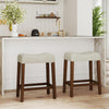 Set of 2 brown upholstered counter height bar stools with curved saddle seats, ideal for kitchen or bar use.