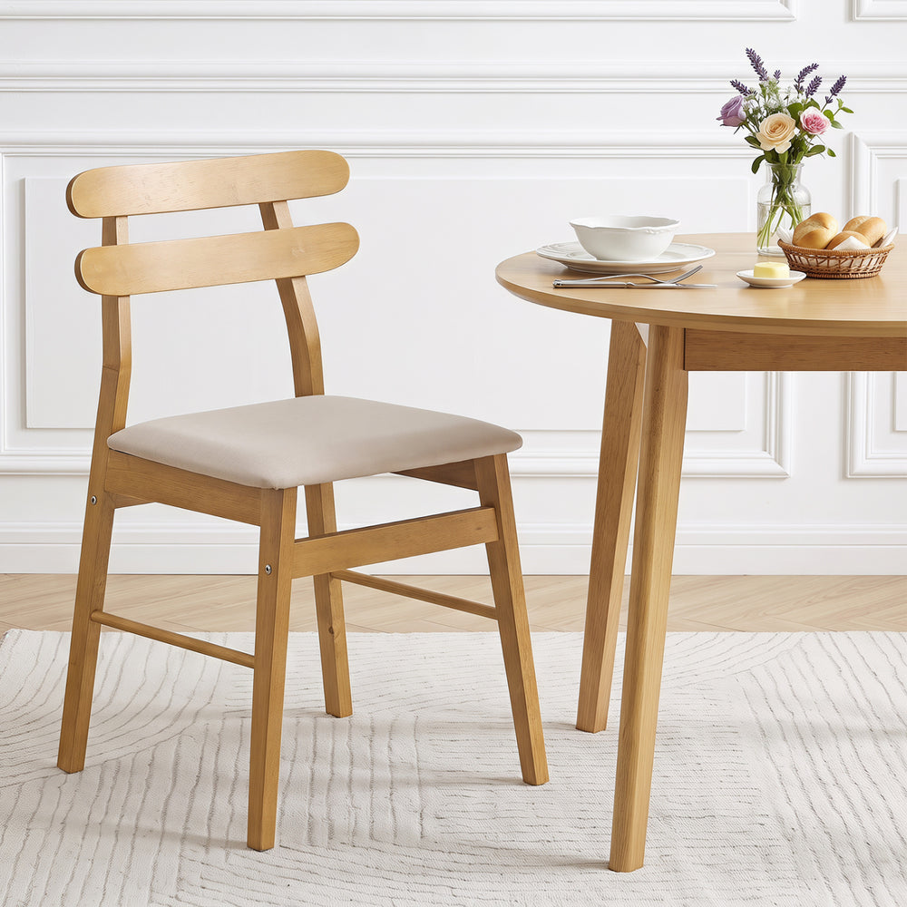 Natural rubber wood dining chair with a beige upholstered seat, designed for comfort and long-term use in modern spaces.