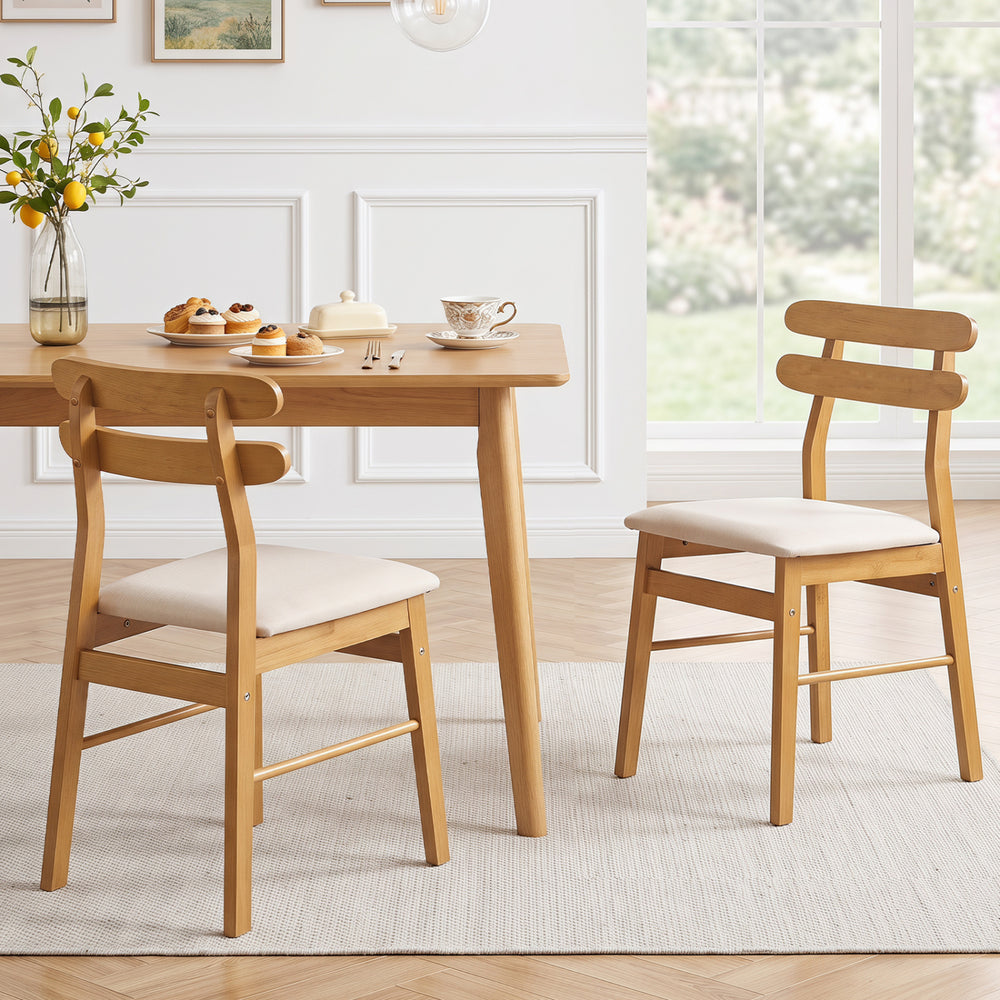Set of 2 upholstered dining chairs in natural wood with beige fabric, designed for comfort and elegance in dining spaces.