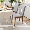 Upholstered dining chairs with padded seat and nailhead trim in walnut finish, perfect for elegant dining areas.