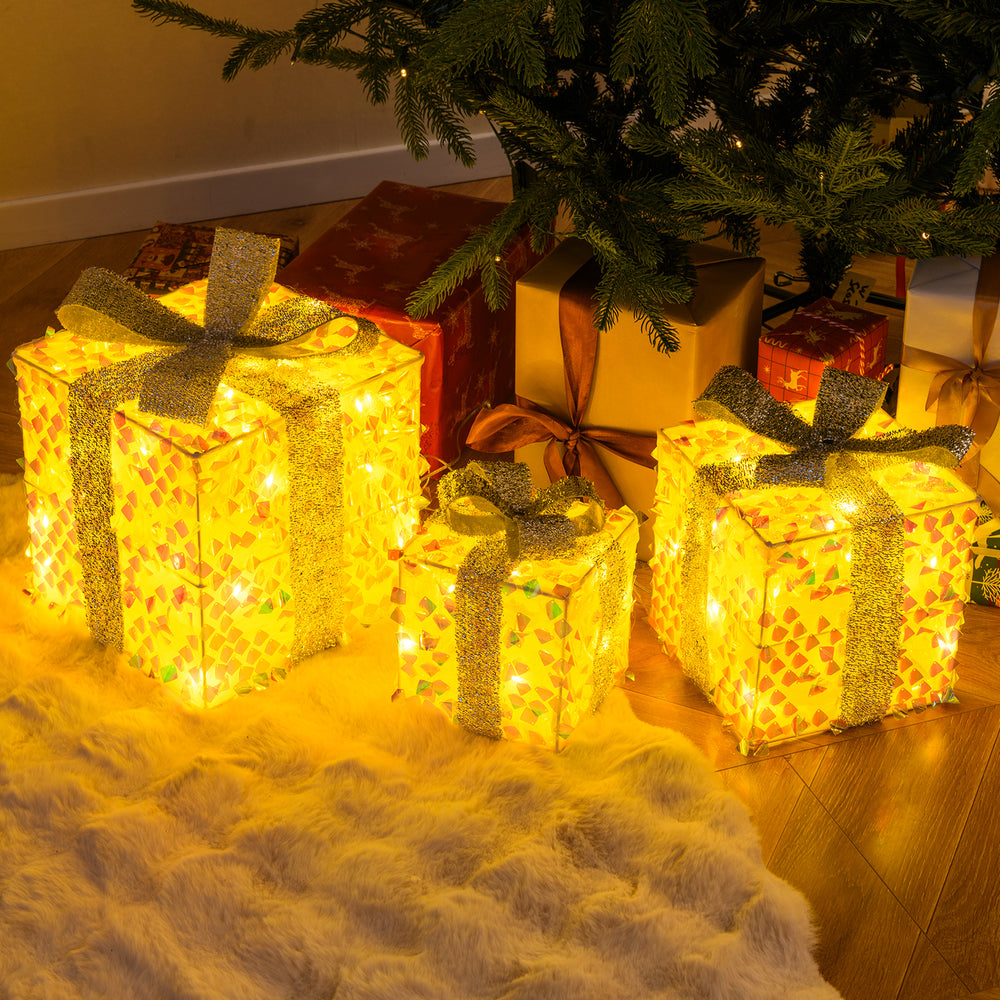 Set of 3 illuminated Christmas gift boxes with shimmering sequins, festive bows, and warm LED lights for holiday charm.