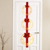 Three lighted Christmas wreaths with warm white LED lights and bows, hung on a red ribbon for festive doorway decor.