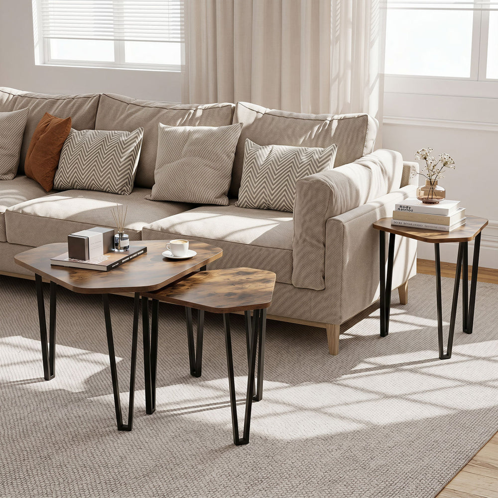 Nesting coffee tables with engineered wood tops and metal frames in rustic brown, perfect for versatile living room setups.
