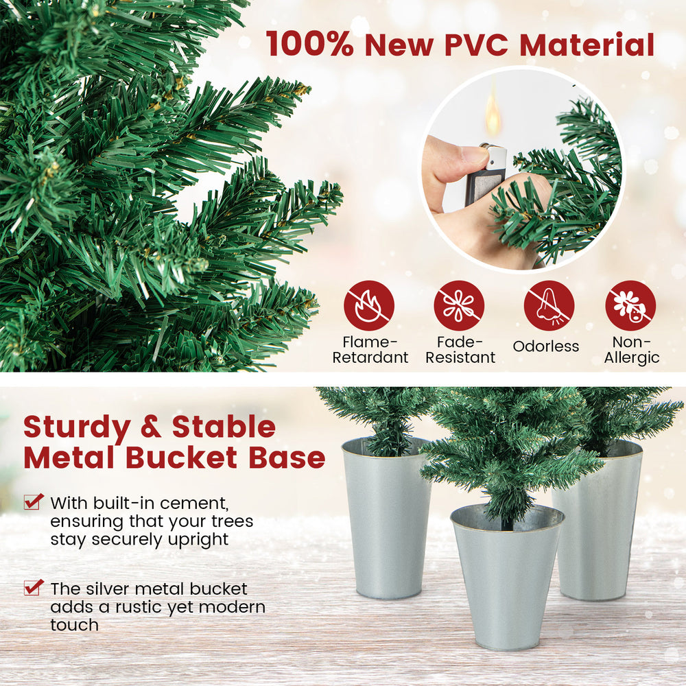 Potted artificial Christmas trees in silver metal buckets, made of flame-retardant PVC, ideal for festive decor.