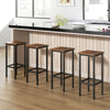 Set of 4 rustic brown bar stools with metal legs, featuring ergonomic footrests for comfort at a kitchen island.