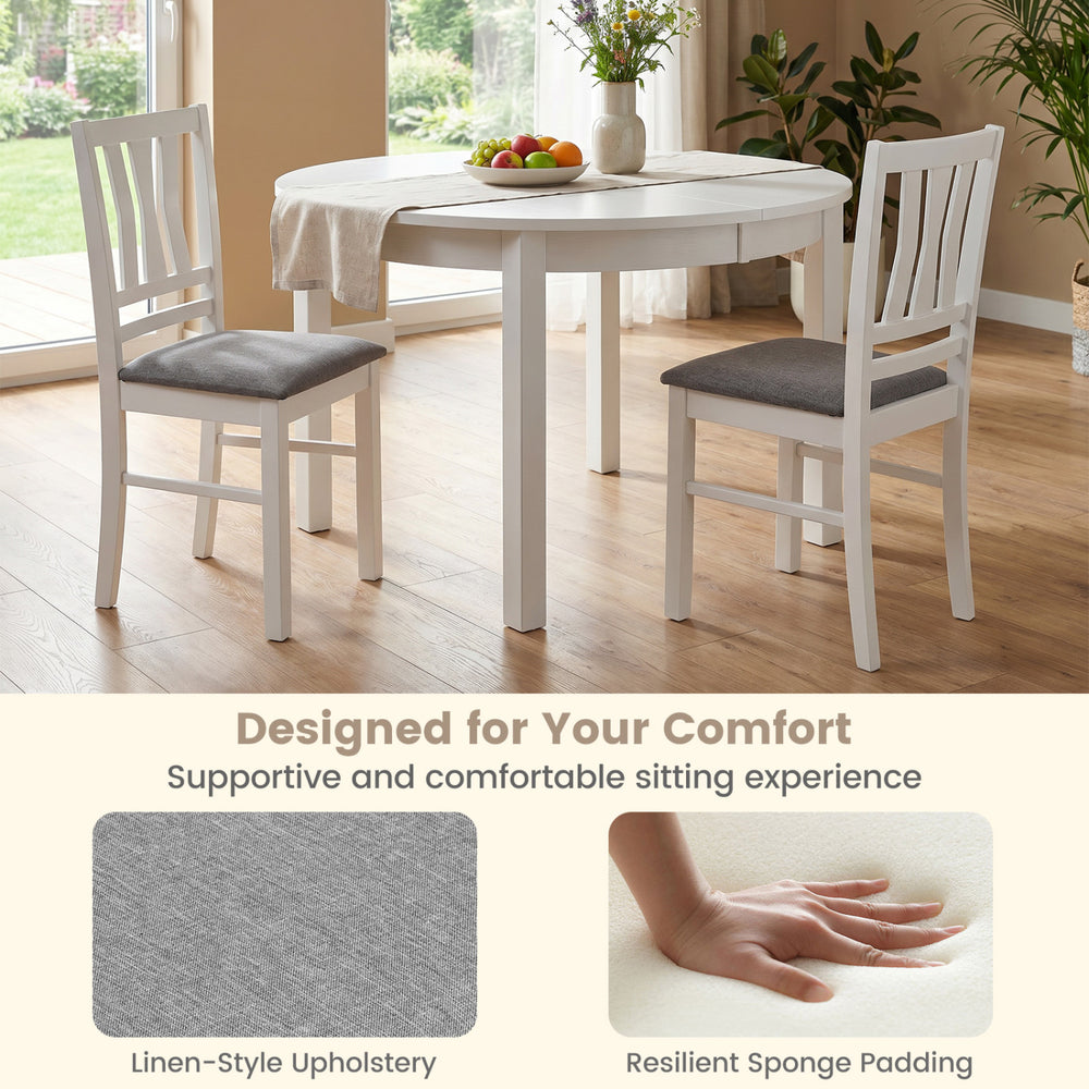 Set of 4 white kitchen chairs with linen-style upholstery and slatted backrest for comfortable dining experiences.