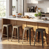 Set of 4 gun metal metal bar stools with backrests, stacked for space-saving convenience in a modern kitchen.