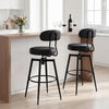 Set of two black swivel barstools with padded faux leather seats and curved backrests, ideal for modern kitchens.