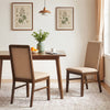 Upholstered dining chairs with solid rubber wood legs in brown, featuring breathable linen fabric and high backrests.