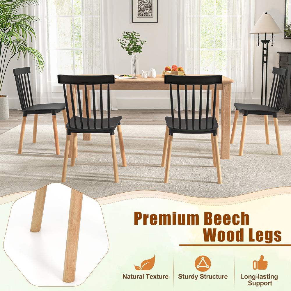 Set of 4 black Windsor dining chairs with spindle backs and beech wood legs, ideal for kitchen and dining room use.