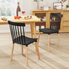 Set of 4 black Windsor dining chairs with spindle backs and curved seats, ideal for kitchen or dining room use.