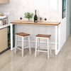 Set of 2 walnut and gray saddle bar stools with acacia wood seats and rubber wood footrests for kitchen islands.