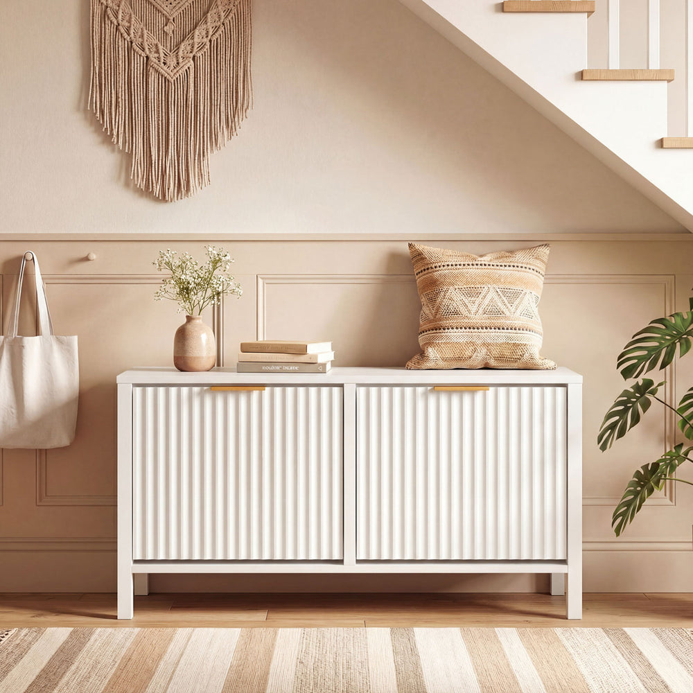 Narrow white shoe storage bench with fluted doors and two flip drawers, perfect for entryways and organized footwear.