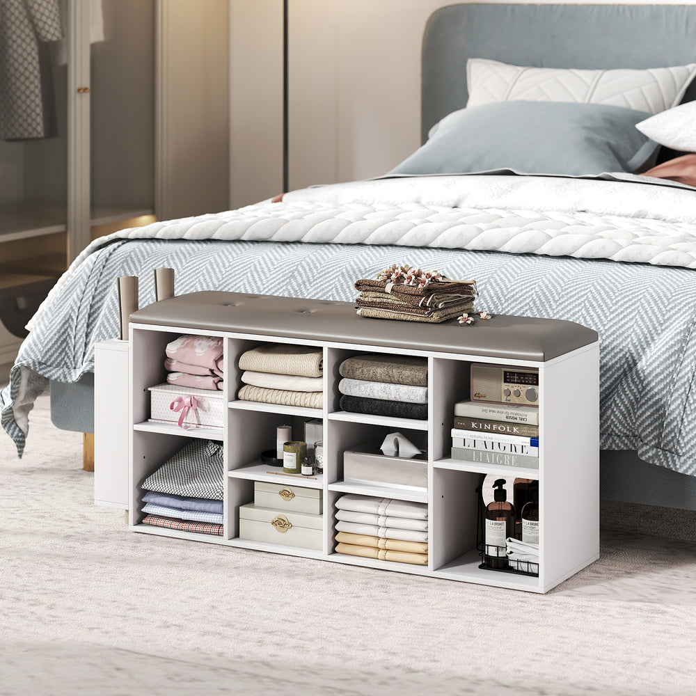 Shoe storage bench in white with umbrella stand, featuring 10 storage cubes and a button-tufted padded seat for.