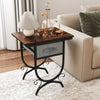Side table with a rustic wood top, fabric drawer, and carved metal frame, perfect for living room or bedroom use.
