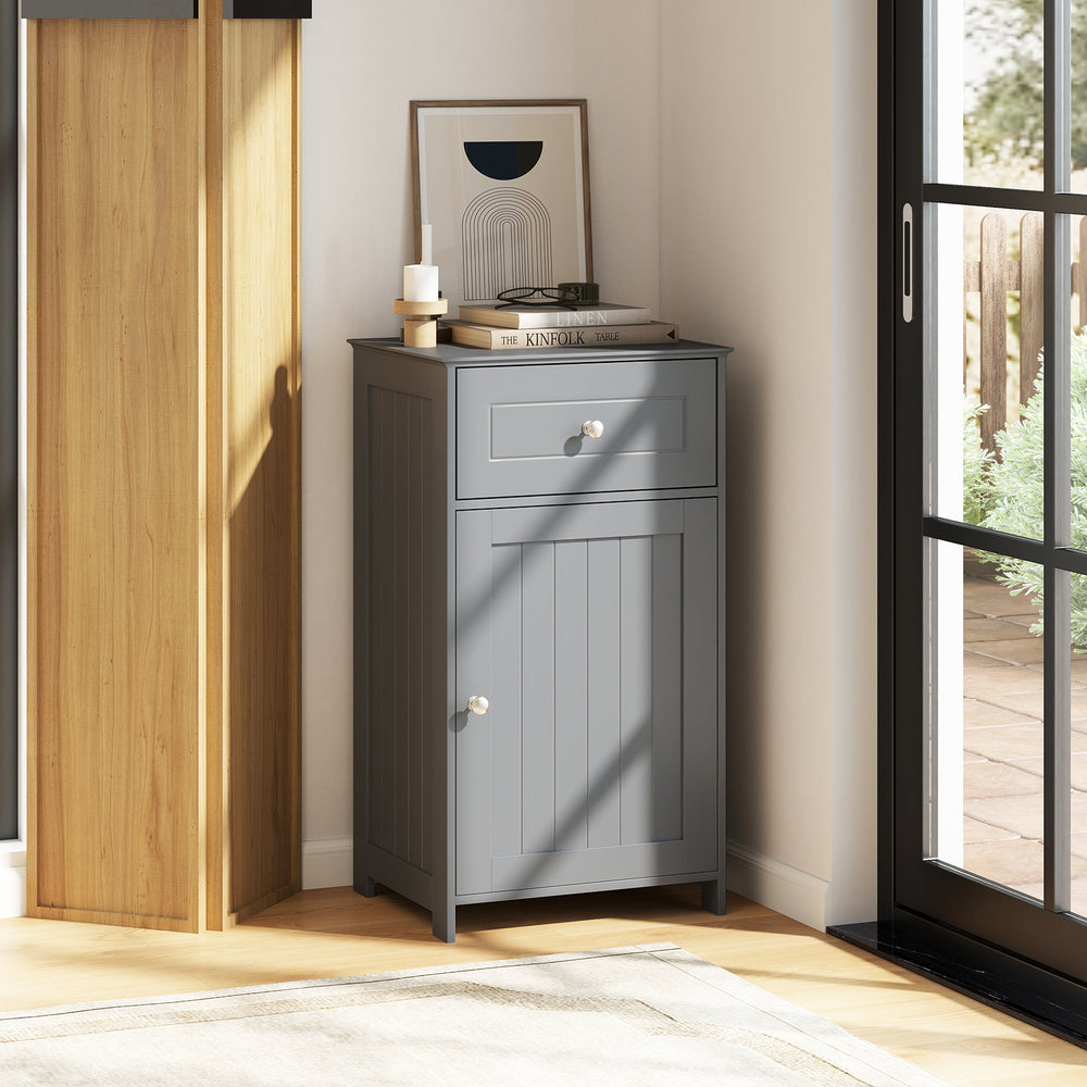 Gray single door bathroom cabinet with adjustable shelf and drawer, featuring a sturdy design for versatile storage.
