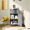 Single door gray bathroom cabinet with open storage shelf, showcasing books and decor for versatile organization.