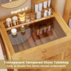Small vanity desk with transparent tempered glass tabletop, featuring bamboo construction and deep storage for taller.