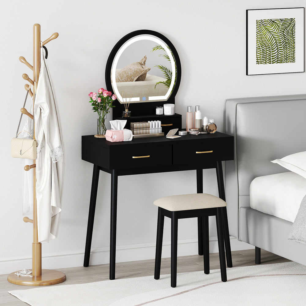 Small black vanity makeup dressing table set with LED lighted mirror and cushioned stool, perfect for compact bedrooms.
