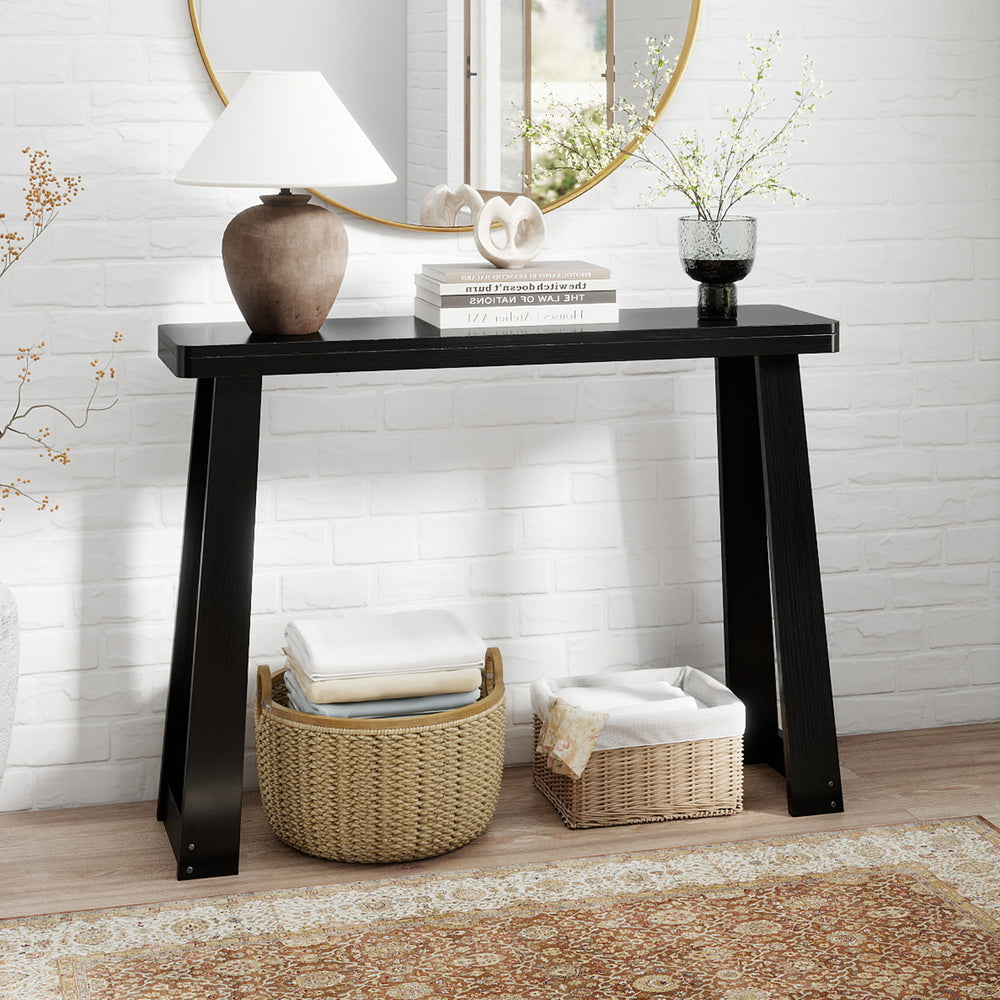Black solid rubber wood console table with a 43" x 12" tabletop, featuring a stable base for entryway or hallway use.
