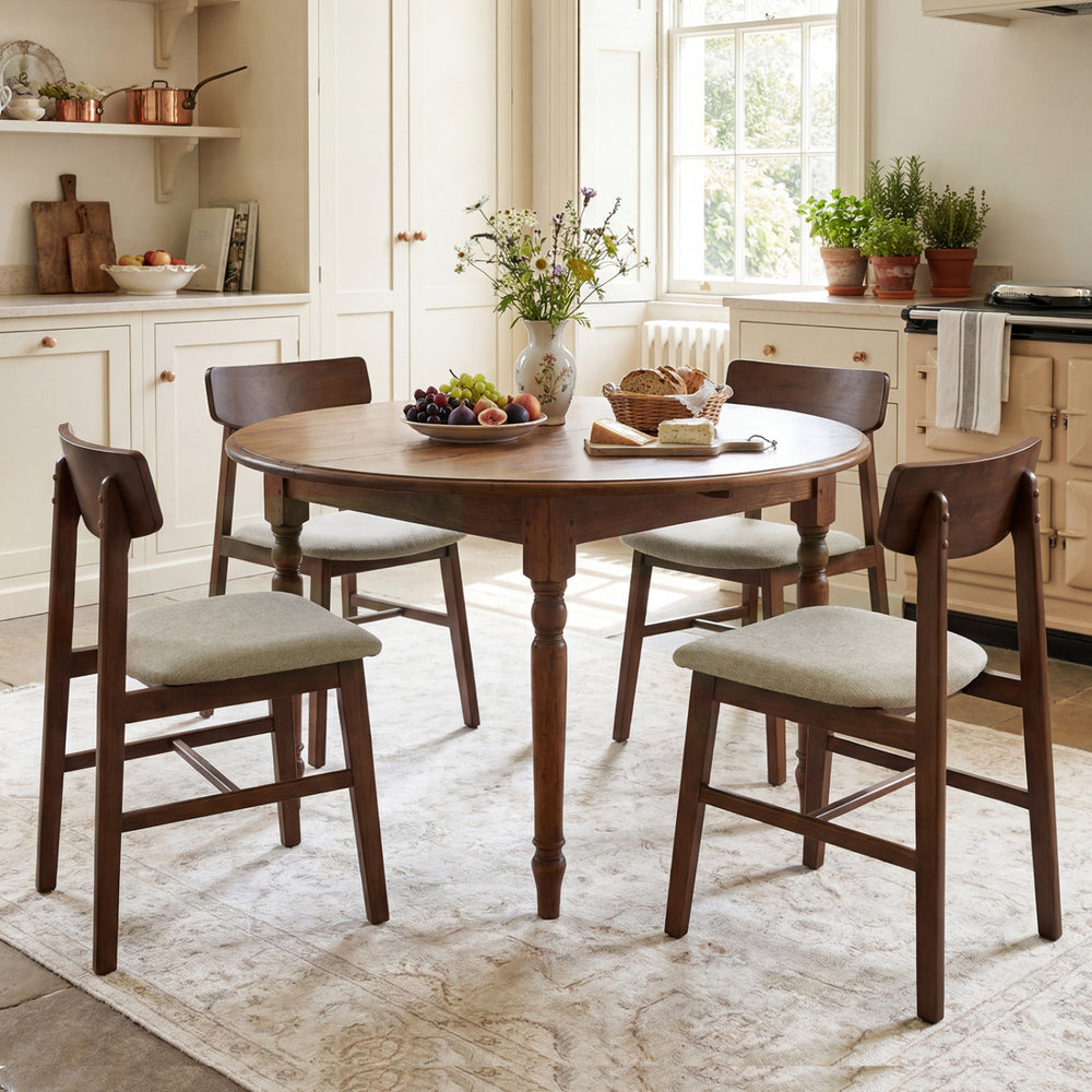 Round dining table set with four walnut solid rubber wood chairs featuring curved backrests, ideal for stylish dining.