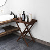 Solid teak wood tray table with removable top, featuring a sleek finish and foldable design for versatile outdoor use.