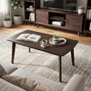 Solid wood modern coffee table with tapered legs in walnut finish, perfect for living room or office use.