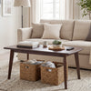 Solid wood modern coffee table with tapered legs in walnut finish, featuring a wide tabletop and unique wood grain.