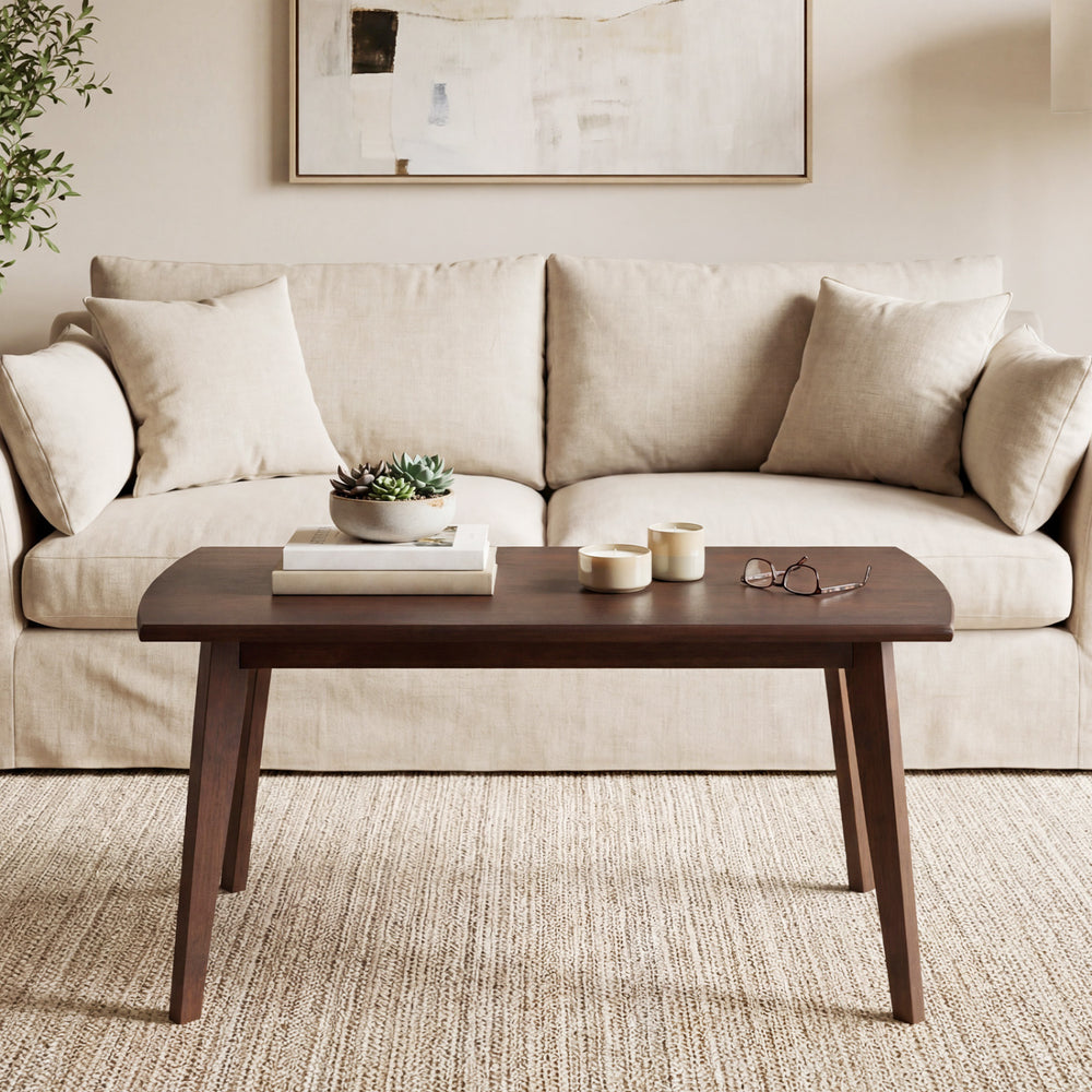 Solid wood modern coffee table with tapered legs in walnut finish, ideal for living room or office use.