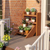 Solid wood plant stand with four tiers, showcasing potted flowers, ideal for porches and balconies.