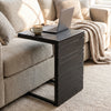 C-shaped side table with a sleek black finish, designed for easy placement beside sofas or beds in indoor and outdoor settings.