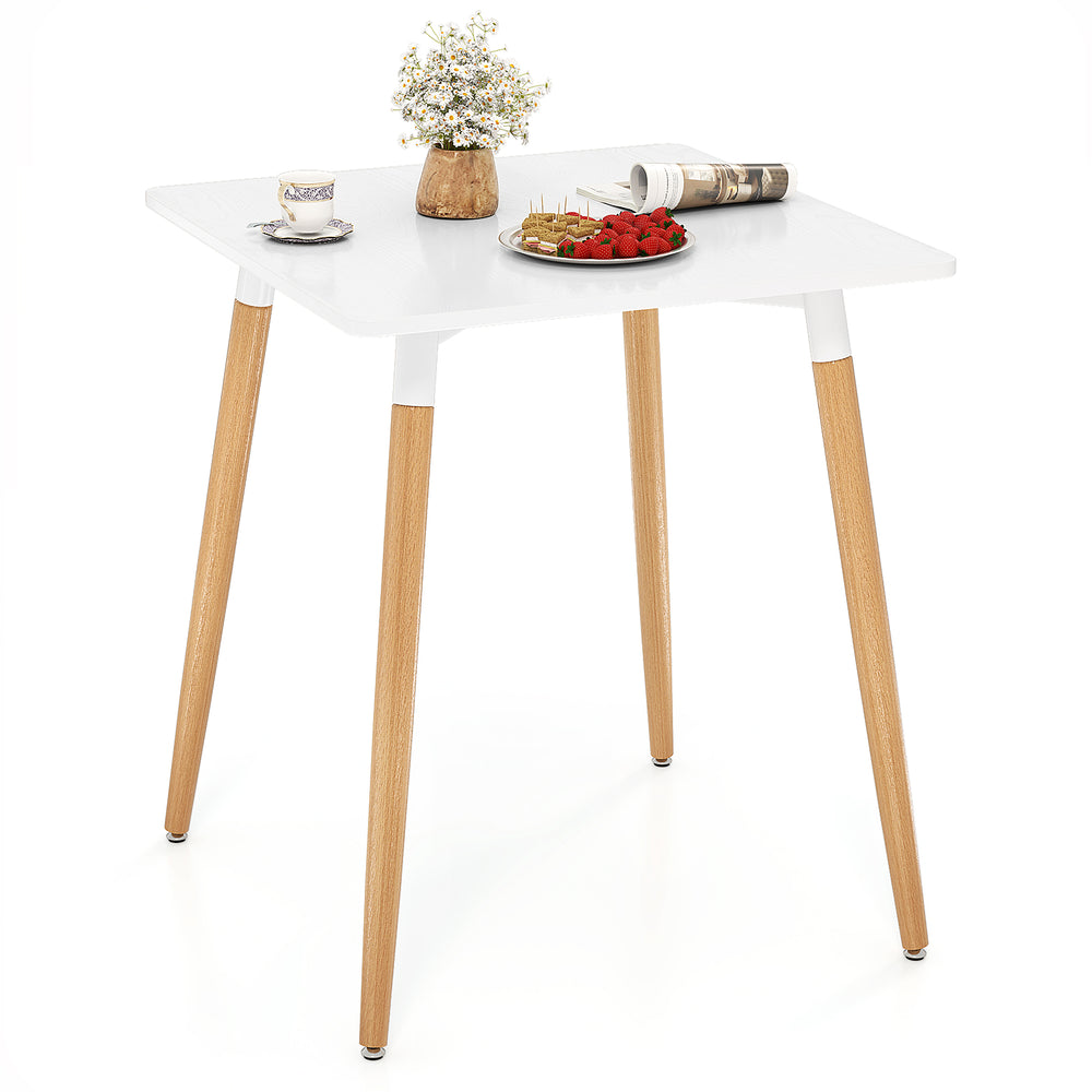 Square dining table with a smooth white surface and wooden legs, designed for easy maintenance and stability on uneven.