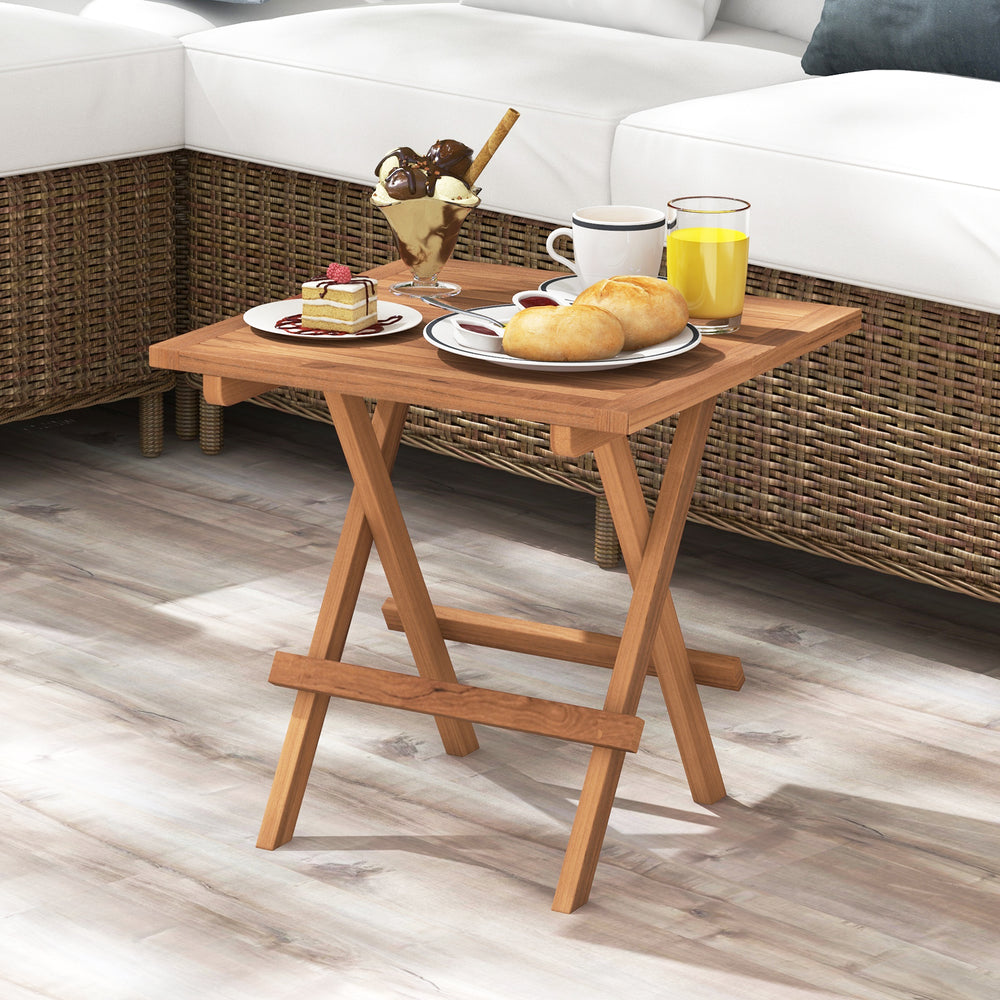 Square patio folding table crafted from teak wood, showcasing a slatted design, perfect for enjoying meals outdoors.