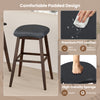 Black swivel bar stool with padded contoured seat, premium PVC leather, and rubber wood legs for kitchen or dining use.