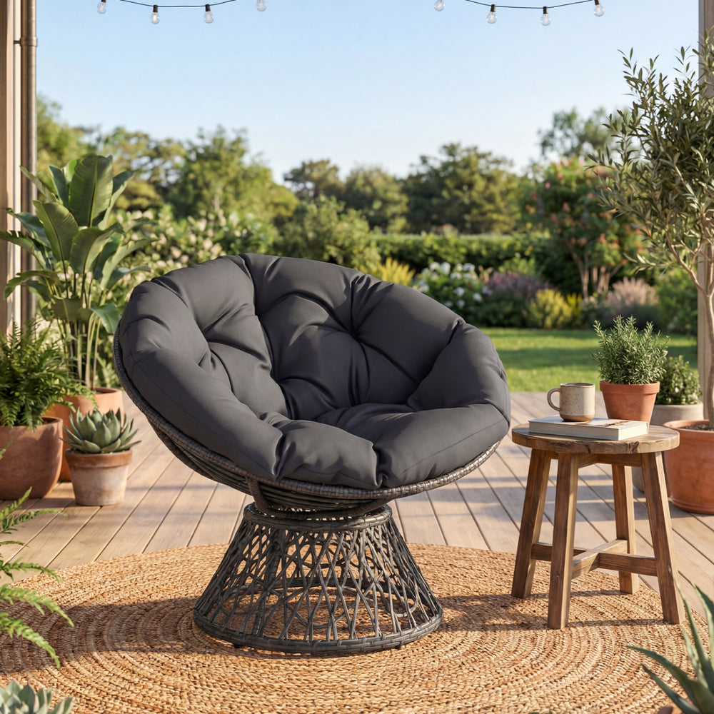 Swivel Papasan chair with thick grey cushion, featuring a round wicker design for outdoor relaxation and comfort.