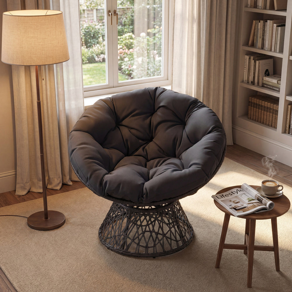Swivel Papasan chair with thick grey cushion, featuring a sturdy metal base, perfect for living room or patio.