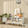 Mid-century modern white TV stand with rattan cabinets and open shelves, ideal for organizing entertainment equipment.